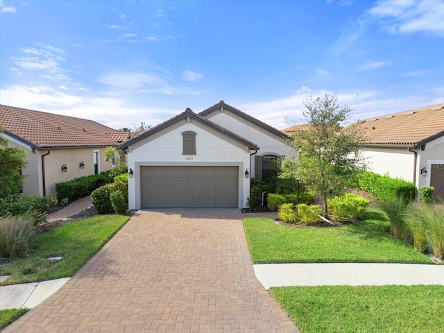 single story home with a garage and a front lawn