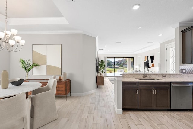 kitchen with dark brown cabinetry, dishwasher, sink, decorative light fixtures, and light wood-type flooring