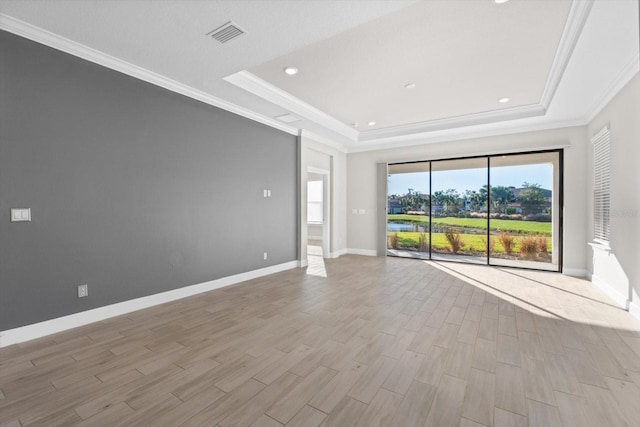 unfurnished living room with a raised ceiling, light hardwood / wood-style floors, and ornamental molding