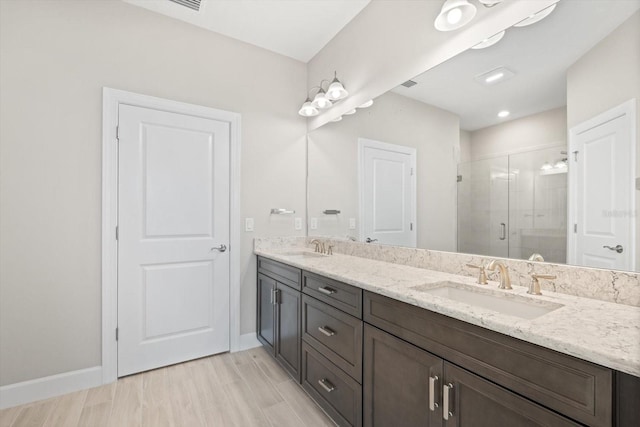 bathroom featuring vanity, a shower with shower door, and hardwood / wood-style flooring