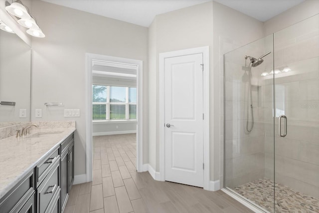 bathroom with vanity and a shower with door