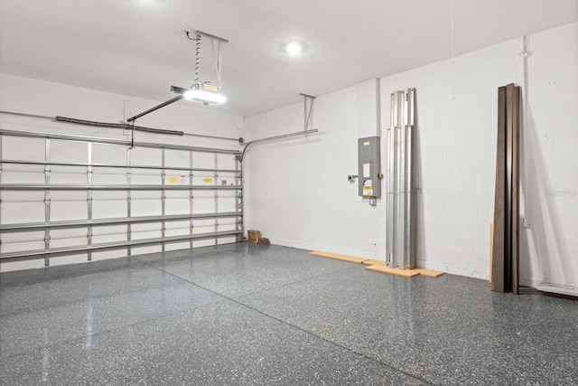 garage featuring electric panel and a garage door opener