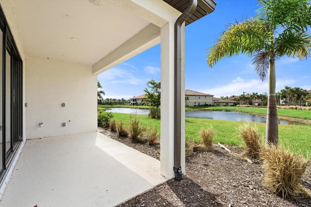 view of patio with a water view