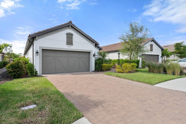 view of front of house featuring a garage and a front lawn