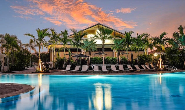 view of pool at dusk