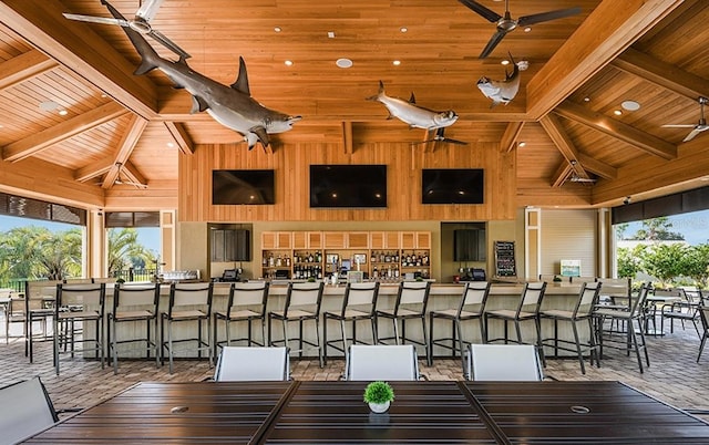 exterior space featuring beamed ceiling, a healthy amount of sunlight, and high vaulted ceiling