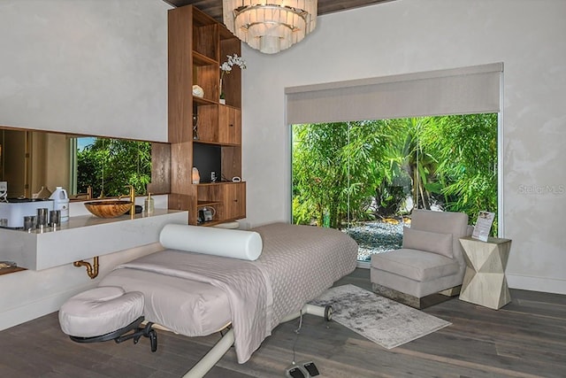 bedroom featuring dark hardwood / wood-style floors and an inviting chandelier