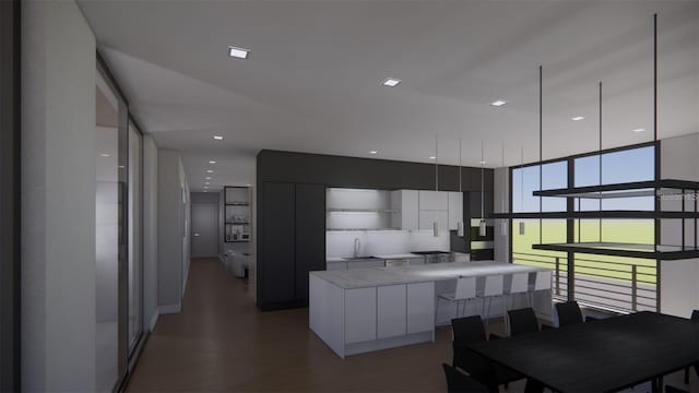 kitchen featuring a kitchen island, wood-type flooring, white cabinetry, and sink