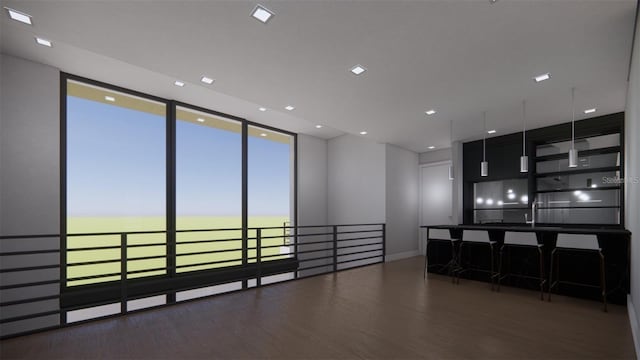 kitchen featuring a kitchen bar and dark hardwood / wood-style floors