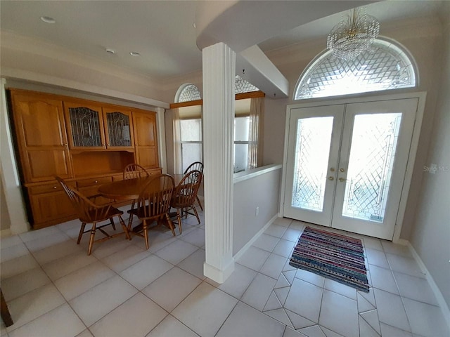 foyer entrance with french doors, plenty of natural light, and light tile patterned floors