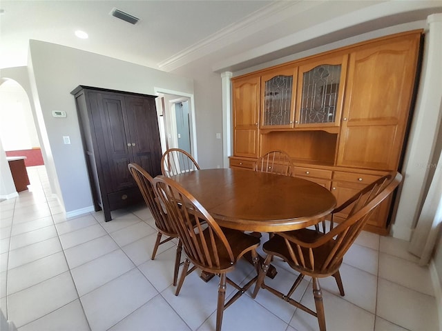 tiled dining area featuring ornamental molding