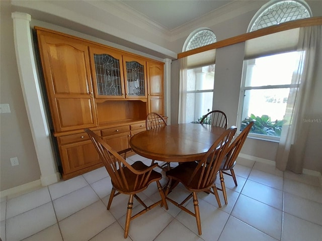 tiled dining area with ornate columns and ornamental molding