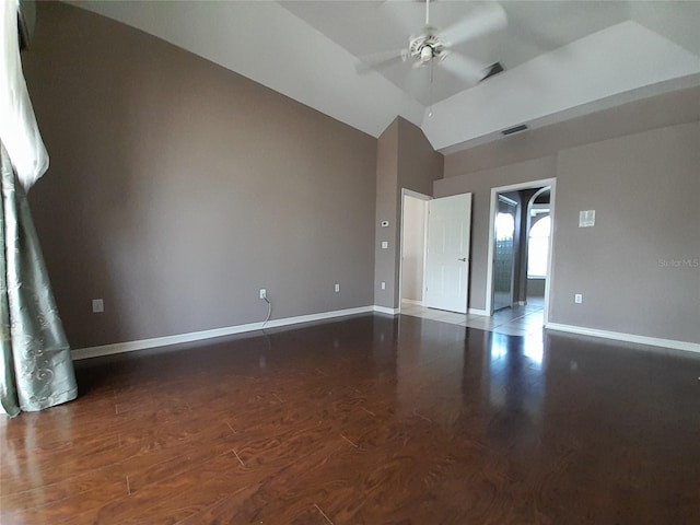 spare room with dark hardwood / wood-style floors, ceiling fan, and vaulted ceiling