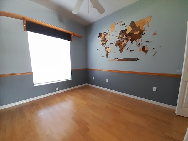 empty room with ceiling fan and wood-type flooring