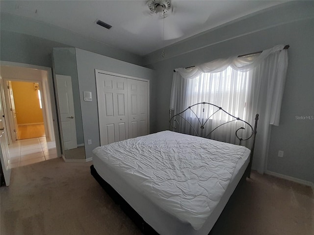 carpeted bedroom featuring a closet and ceiling fan