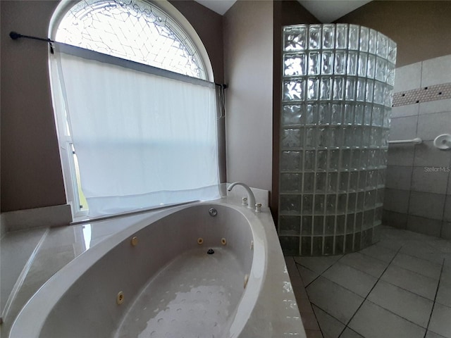 bathroom featuring tile patterned floors and tiled tub