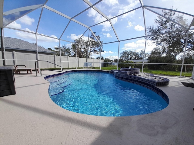 view of swimming pool featuring glass enclosure and a patio area