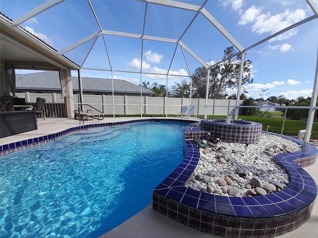 view of pool featuring glass enclosure and a patio area