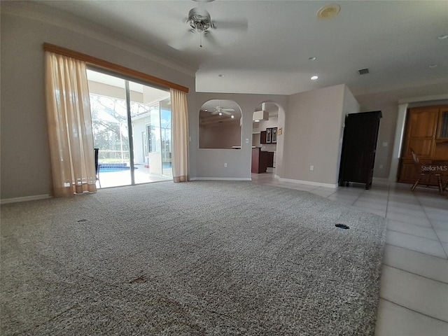 unfurnished living room featuring light carpet and ceiling fan