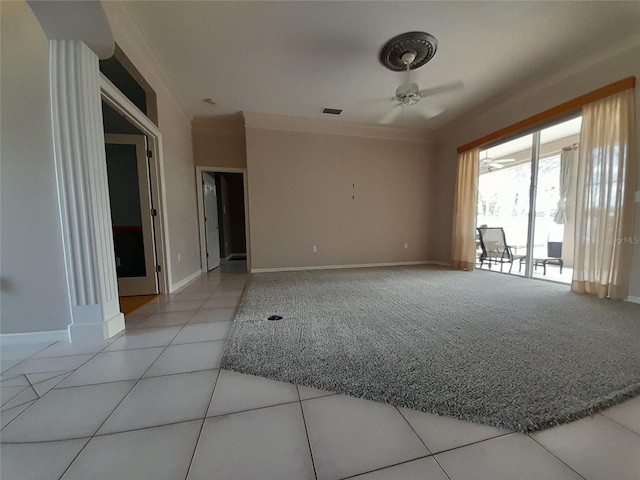 empty room with ceiling fan, crown molding, and light tile patterned floors