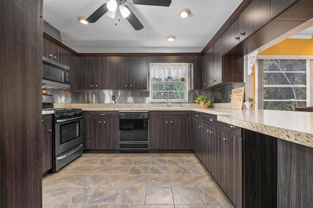 kitchen featuring dark brown cabinetry, sink, and appliances with stainless steel finishes