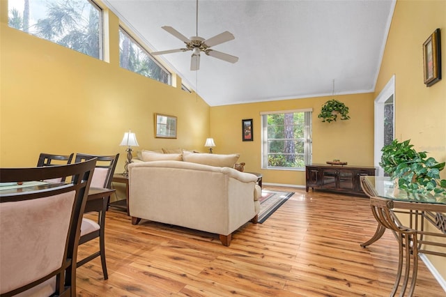 living room featuring ceiling fan, high vaulted ceiling, and light hardwood / wood-style floors