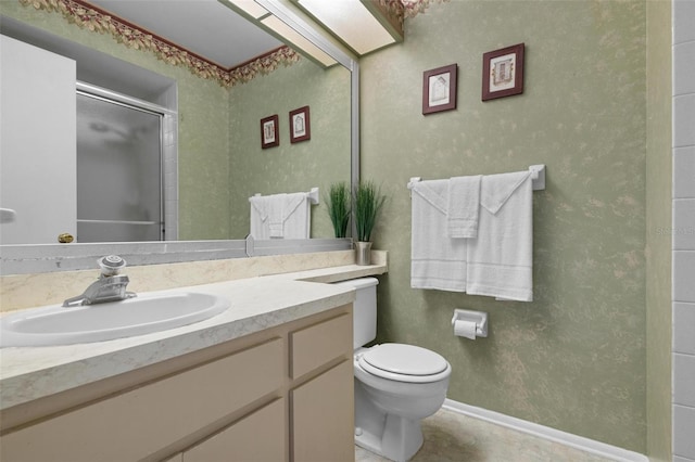 bathroom with vanity, an enclosed shower, and toilet