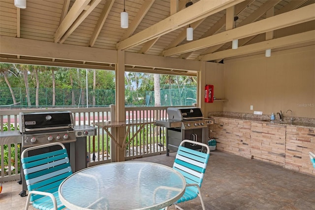 sunroom / solarium with beam ceiling and sink