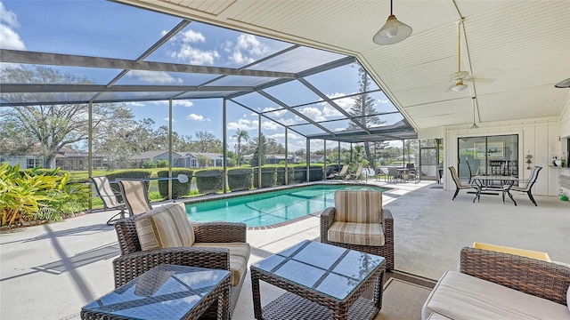 view of pool with a patio and glass enclosure