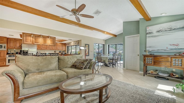 living room featuring a textured ceiling, ceiling fan, light tile patterned floors, and lofted ceiling with beams