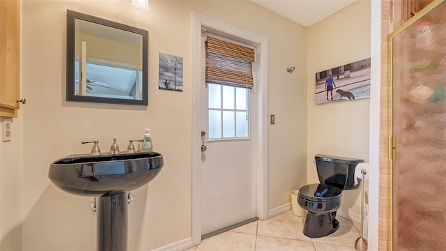 doorway with light tile patterned floors and sink