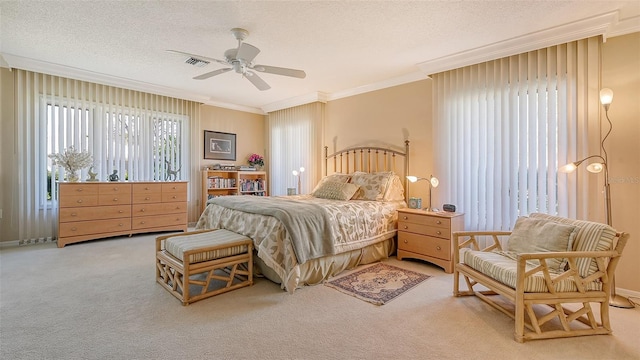 carpeted bedroom featuring ceiling fan, a textured ceiling, and crown molding