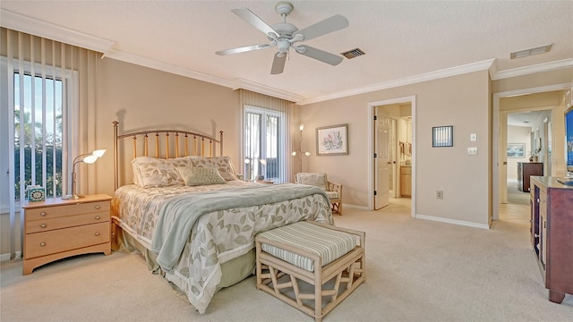 carpeted bedroom featuring a textured ceiling, ceiling fan, crown molding, and connected bathroom