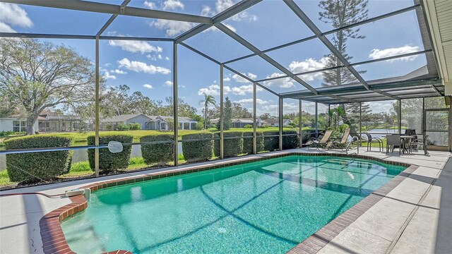 view of pool with a patio area and a lanai