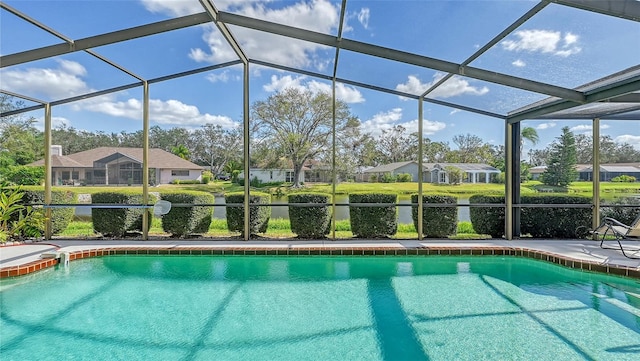 view of swimming pool with a patio area and a lanai