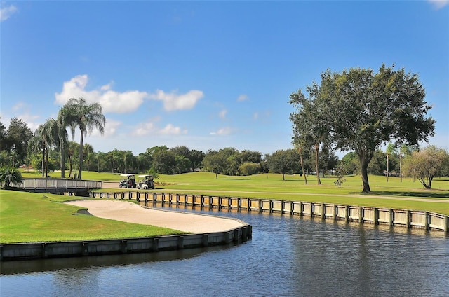 view of community featuring a water view and a lawn