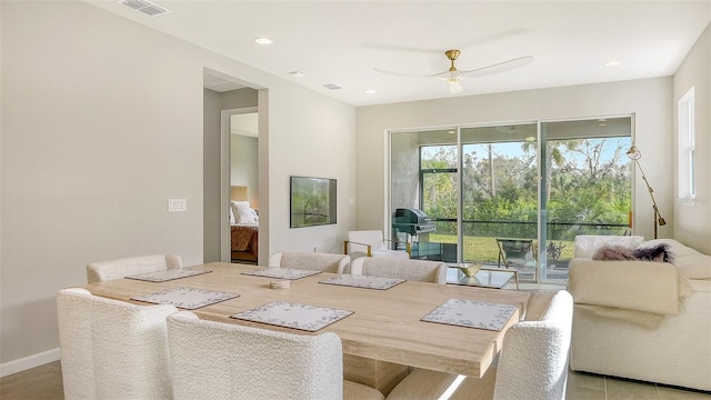 tiled dining area with ceiling fan