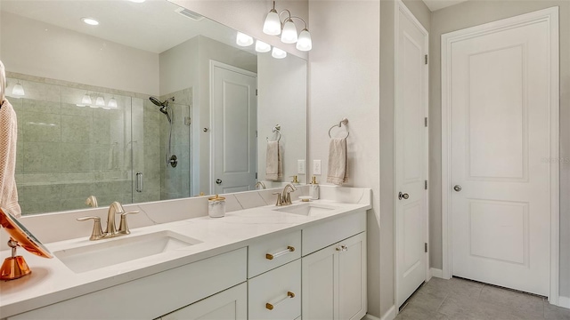 bathroom featuring tile patterned floors, vanity, and a shower with door