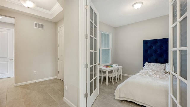 bedroom featuring french doors, light tile patterned floors, and ornamental molding