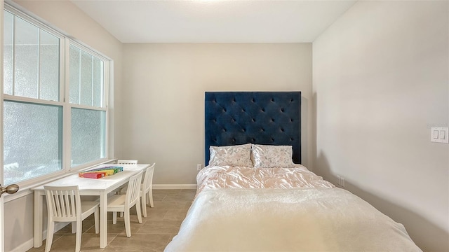 tiled bedroom featuring multiple windows