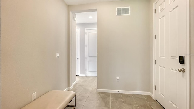 corridor featuring light tile patterned floors