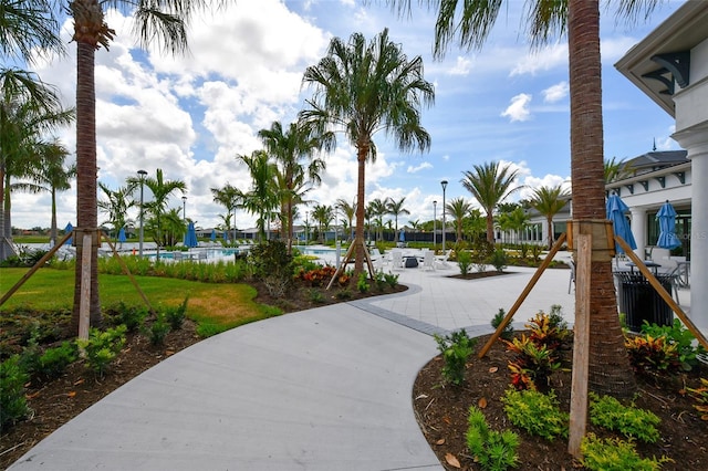 view of home's community featuring a water view and a patio area