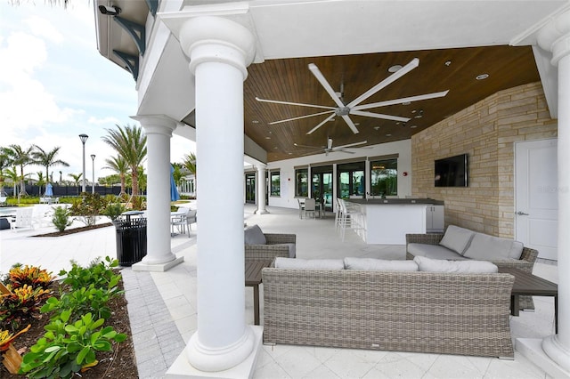 view of patio with outdoor lounge area and ceiling fan