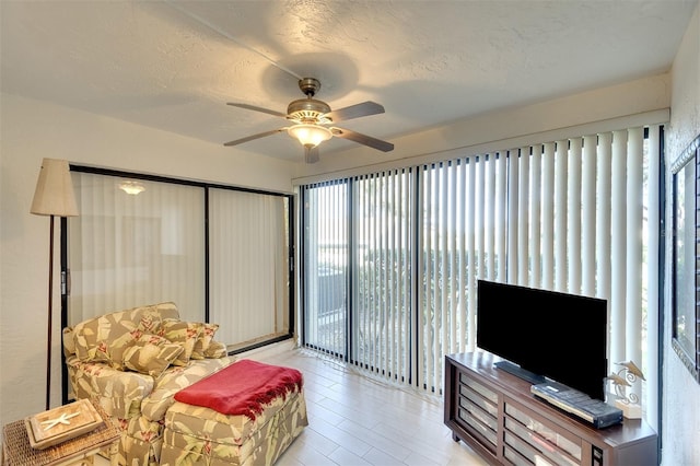 interior space featuring plenty of natural light, ceiling fan, and a textured ceiling