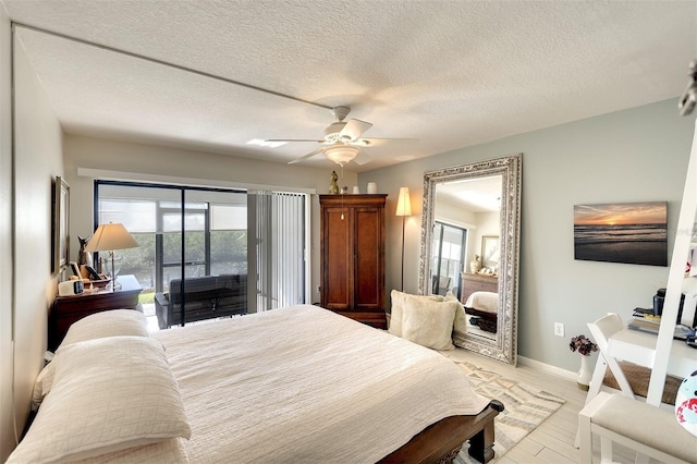 bedroom featuring access to exterior, ceiling fan, light hardwood / wood-style floors, and a textured ceiling