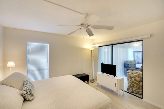 bedroom with ceiling fan and light wood-type flooring