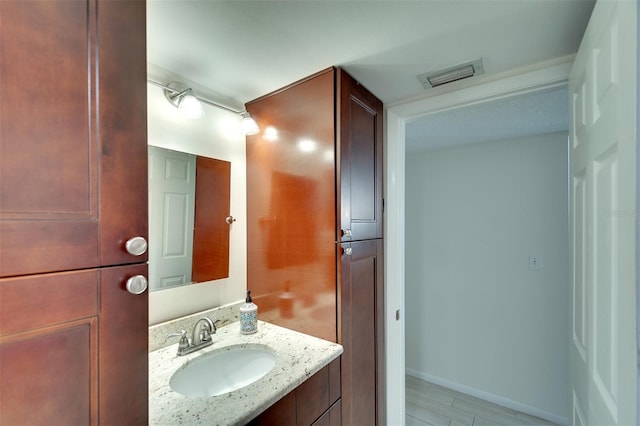 bathroom with hardwood / wood-style flooring and vanity