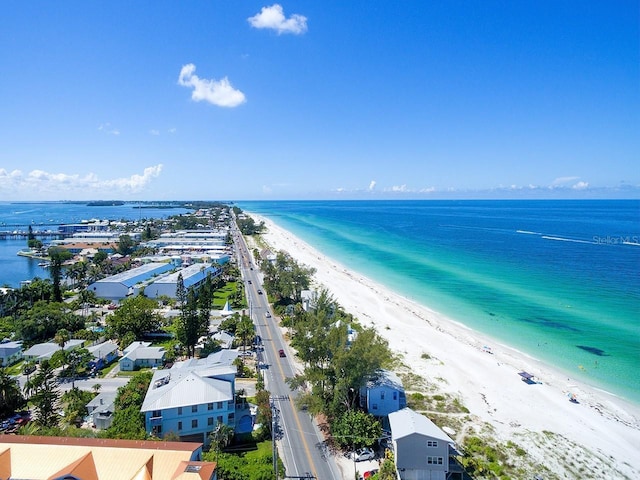 drone / aerial view featuring a beach view and a water view