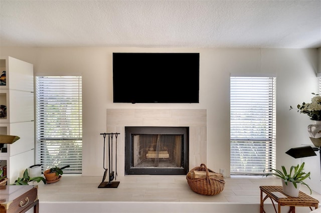 living room featuring a fireplace and a textured ceiling