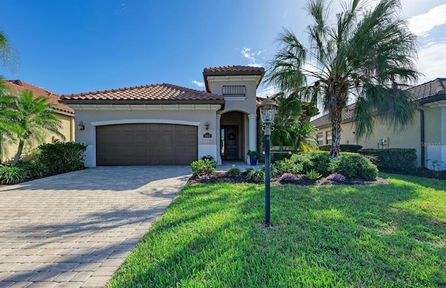 mediterranean / spanish house with a garage and a front lawn